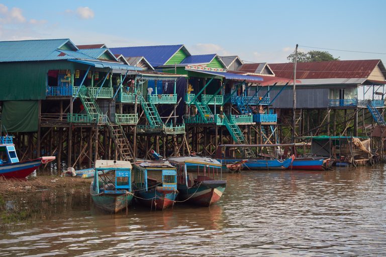 Stilted wooden houses and moored longtail boats at Kampong Phluk on the Tonlé Sap.